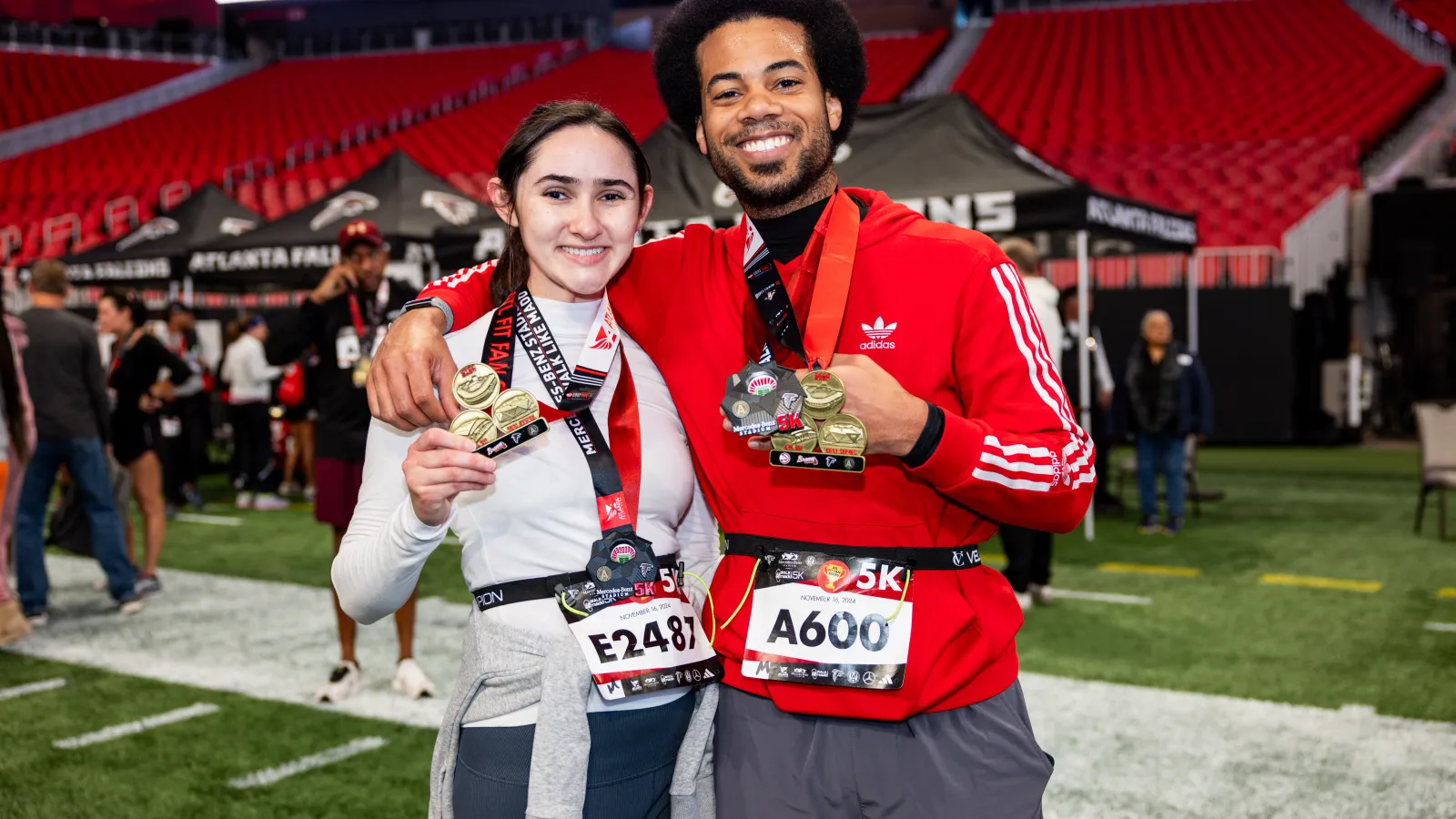 a man and woman holding trophies