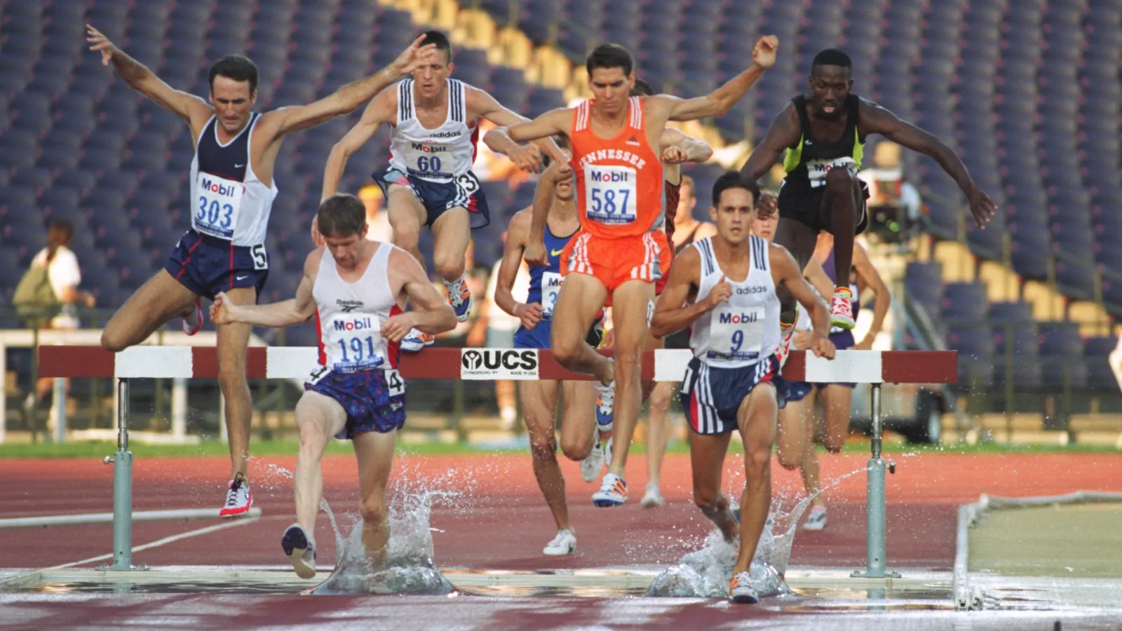 a group of men running on a track