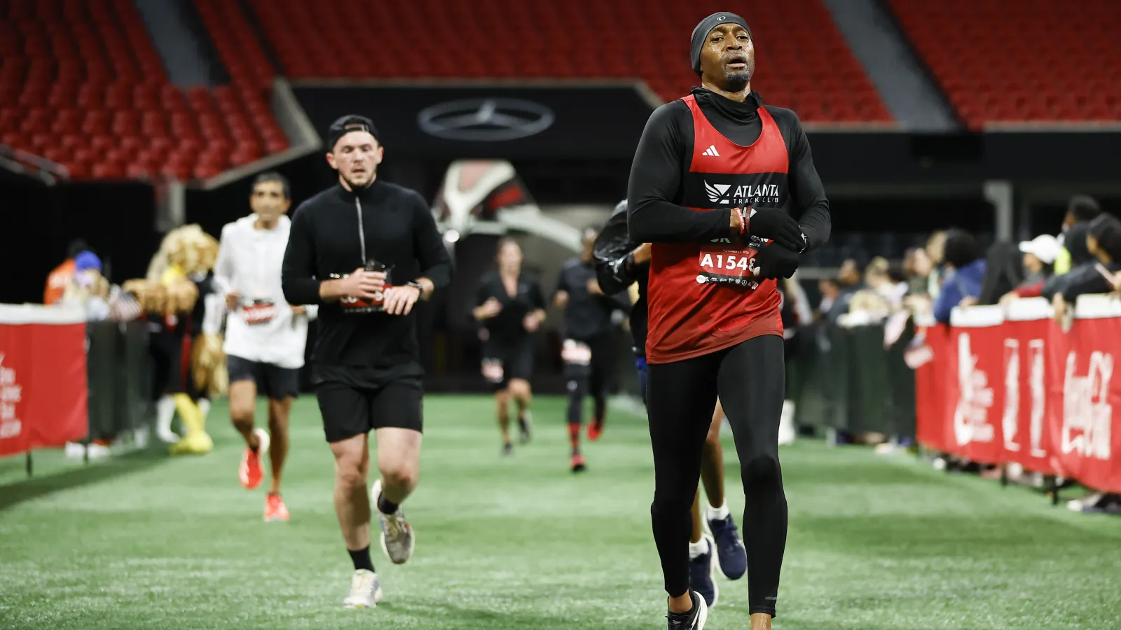 a group of people running on a field