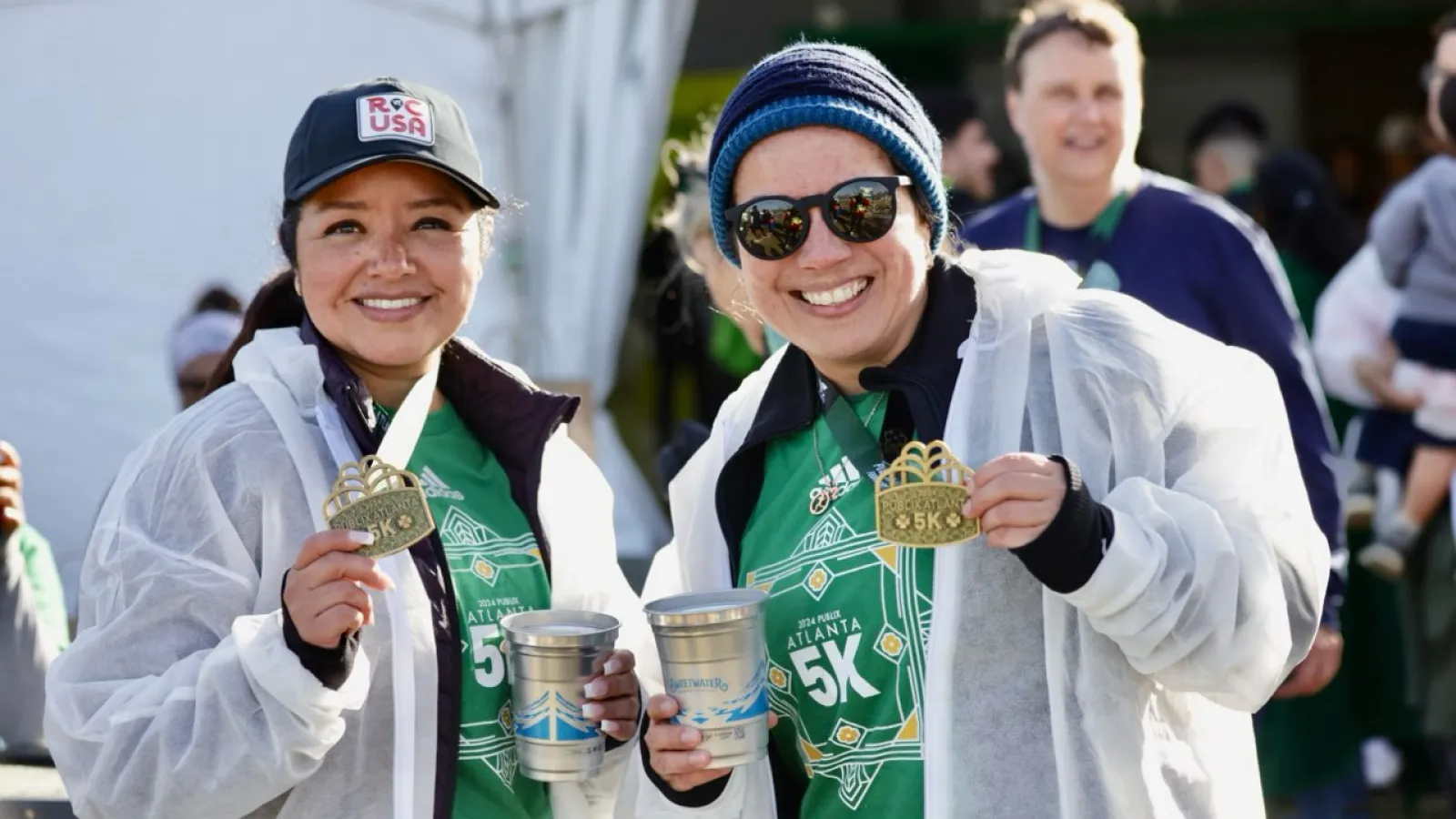 a couple of women holding trophies