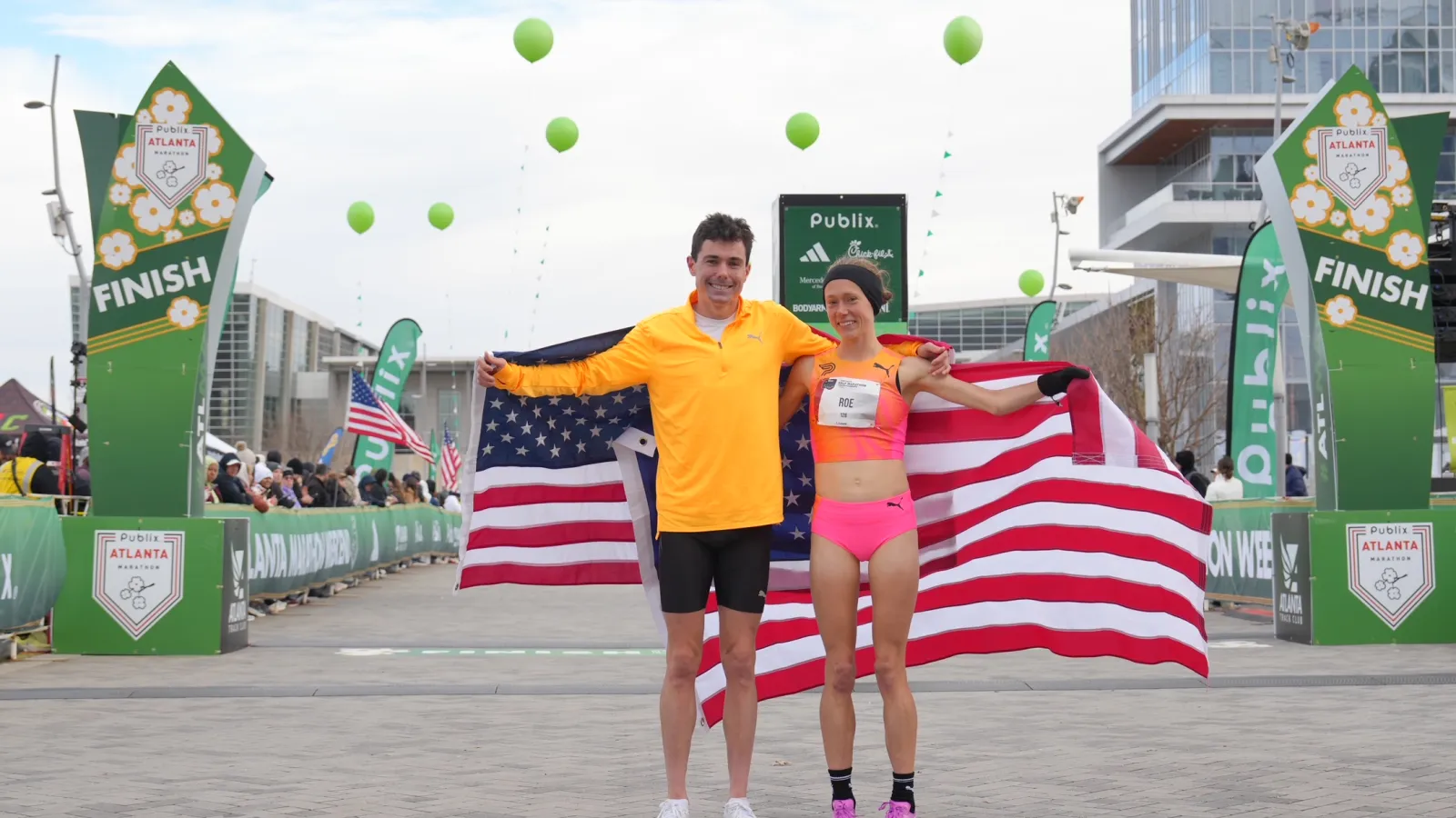 a man and woman holding a flag