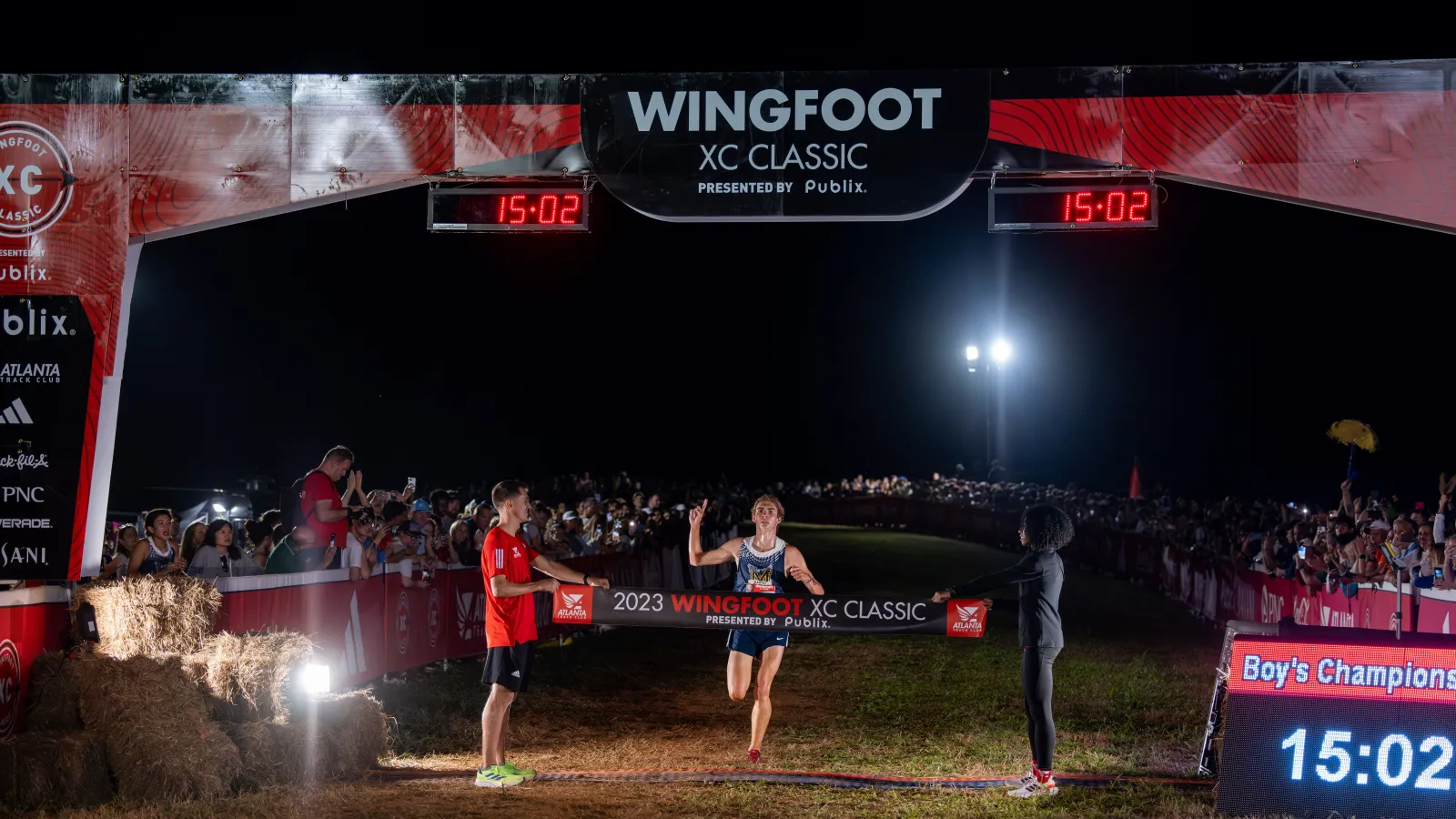 a group of people running on a field at night