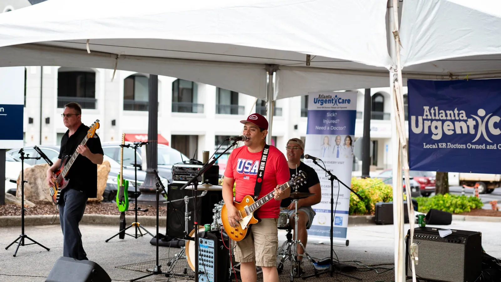 a group of people playing instruments under a tent