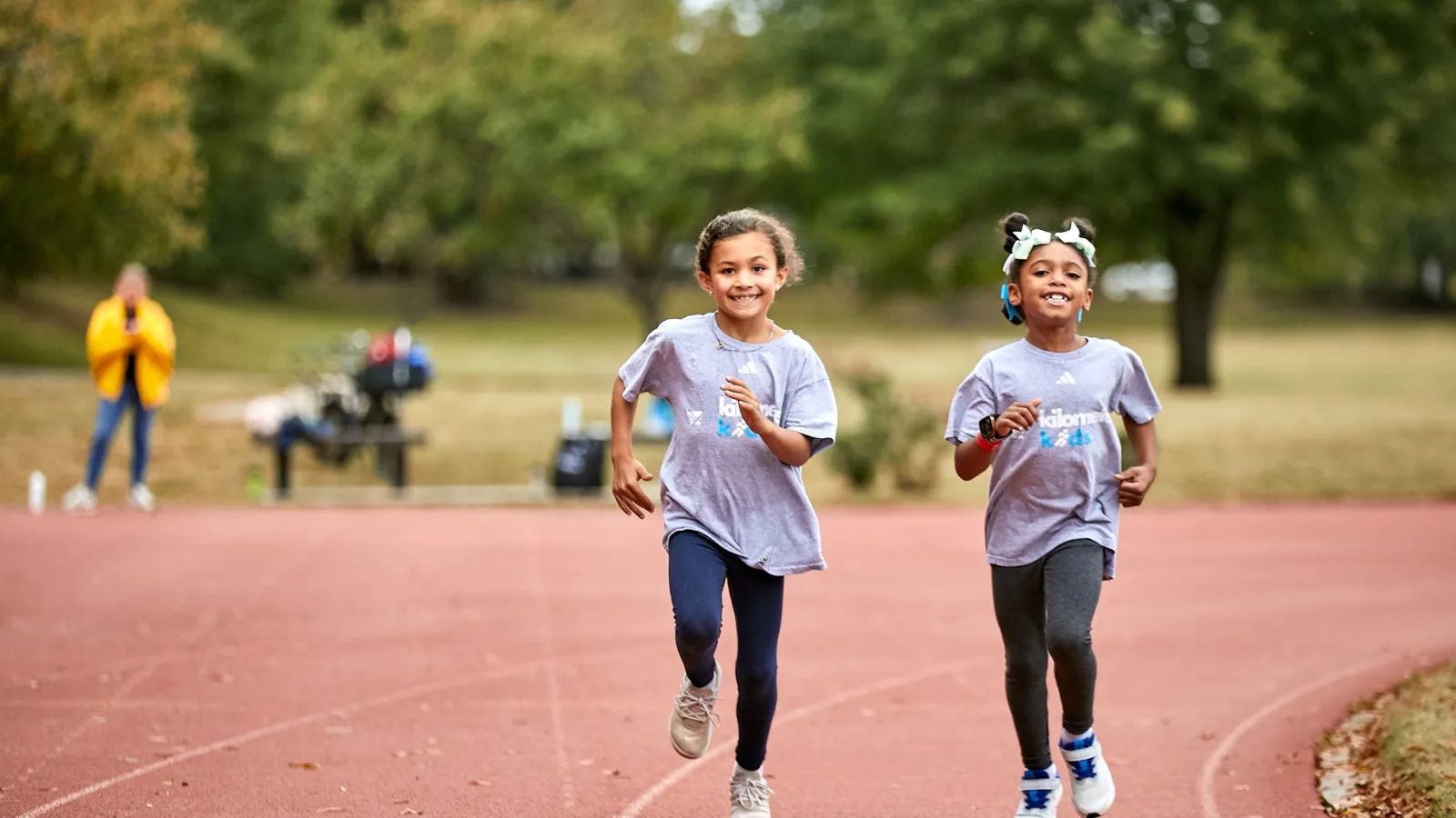 two girls running on a track