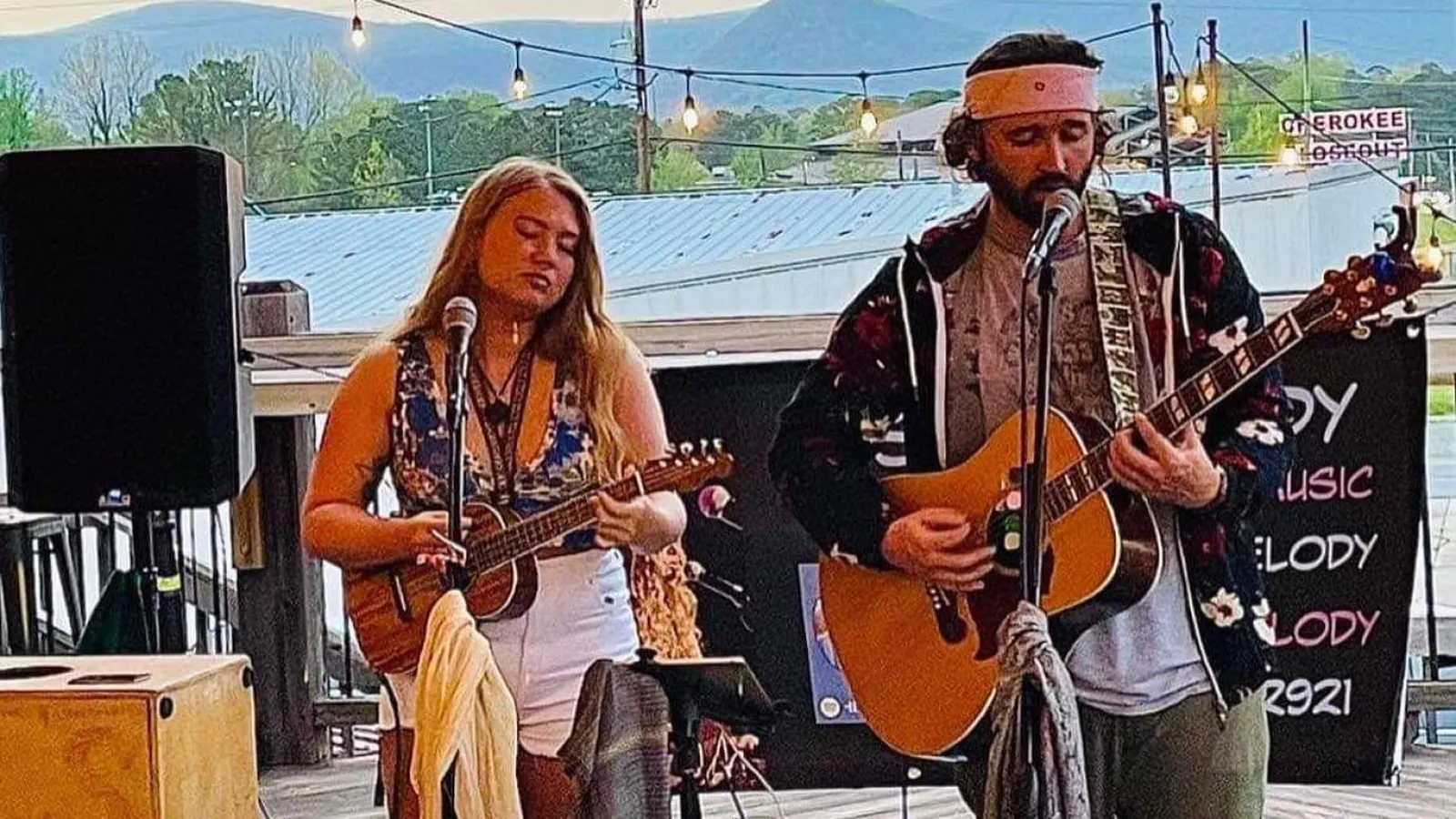a man and woman playing guitars