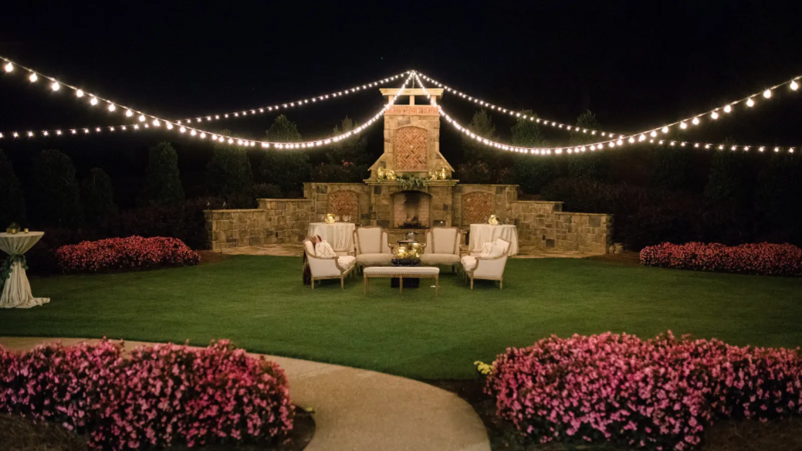 a well lit courtyard with a fountain