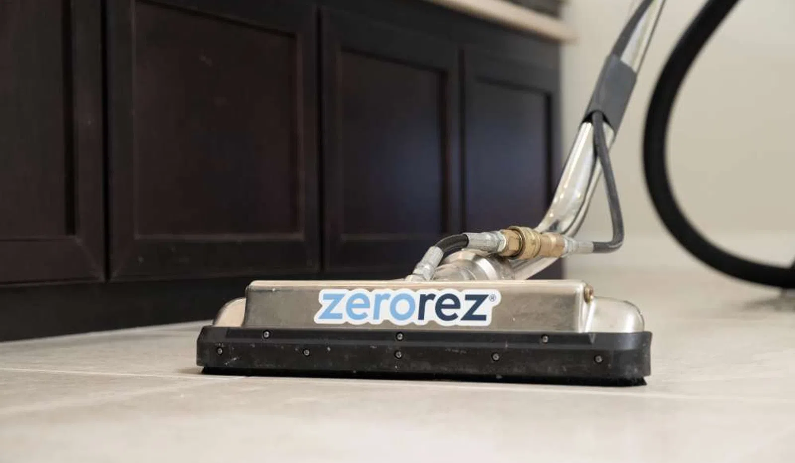 Zerorez floor cleaning machine on tiled floor near dark brown cabinets.