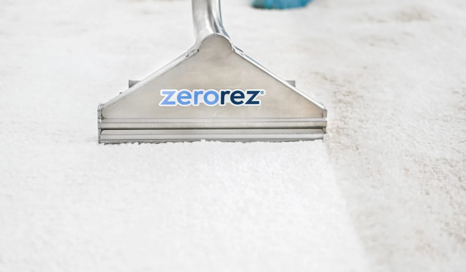 Close-up of a Zerorez carpet cleaning tool on white carpet, highlighting effectiveness and brand logo.