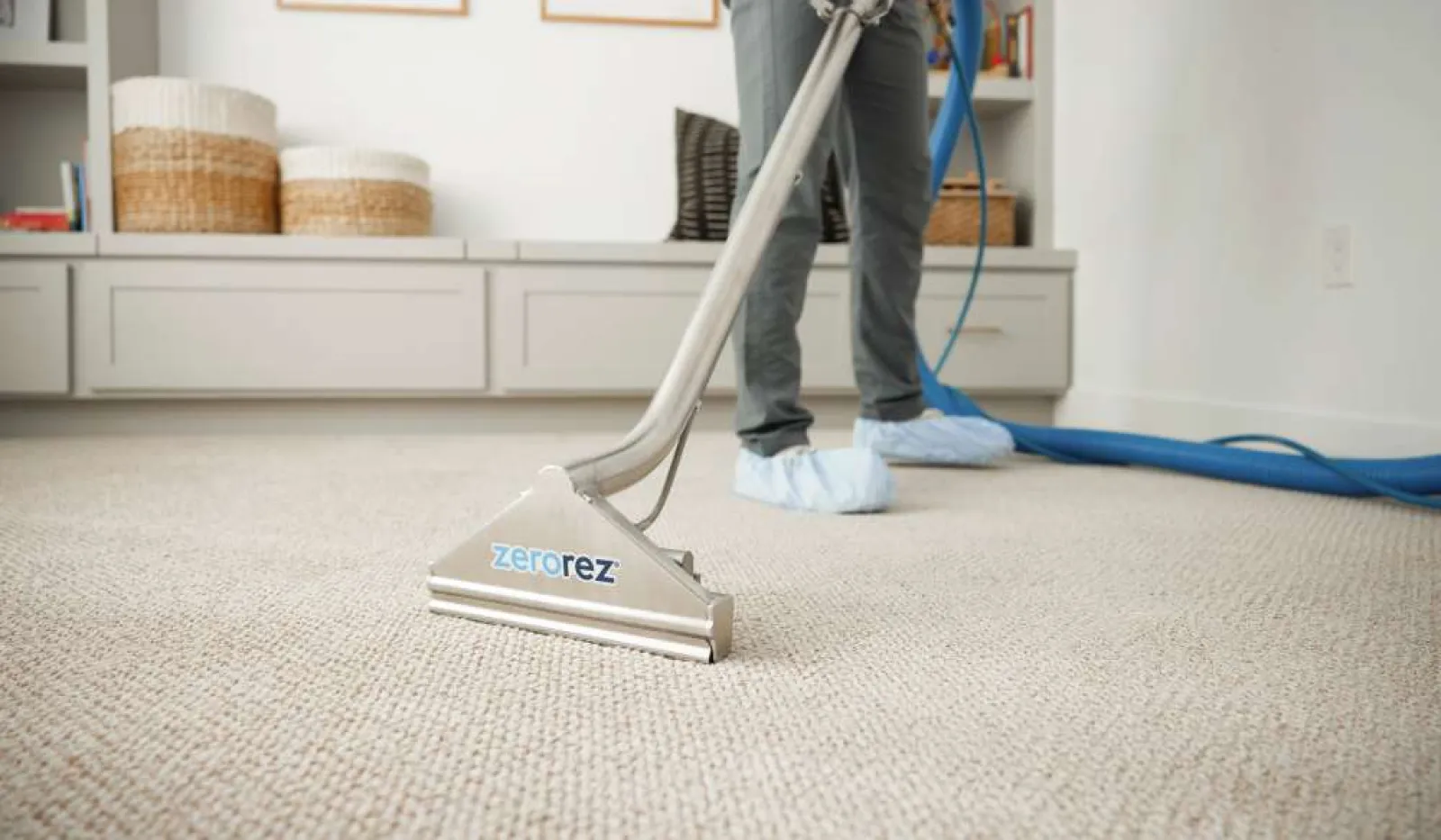 Professional carpet cleaning in a modern living room using Zerorez equipment and tools