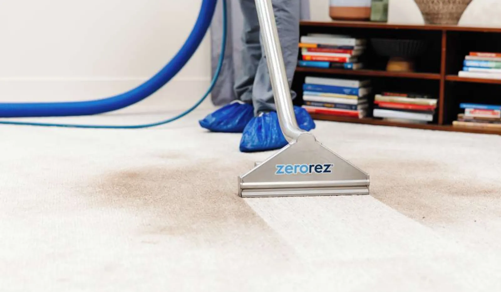 Carpet cleaning machine visibly cleaning dirty carpet showing a clear difference between cleaned and uncleaned areas.