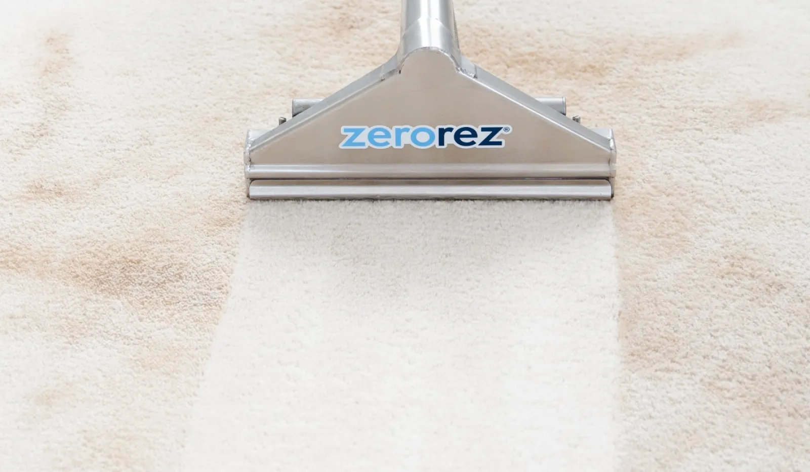 Close-up of Zerorez carpet cleaning wand on a lightly stained carpet, highlighting cleaning power and effectiveness.