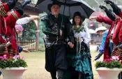 a man and woman holding an umbrella
