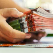 Two hands holding a stack of Folded Brochures