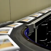Softcover books moving on a conveyor belt in a book manufacturing facility