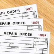 Three repair order forms with sequential ID numbers printed in red