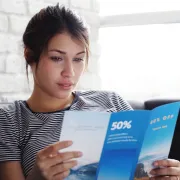 A young woman reading a tri-fold brochure