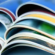 A stack of colorful magazines with Heavy Ink Coverage