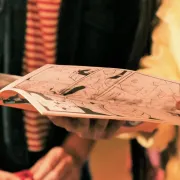 Two people looking through a Comic Book