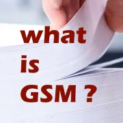 A hand flipping through a stack of paper with the title What is GSM?