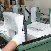 A commercial printing plant worker collating the sections