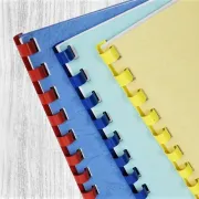 Three Comb Bound books with red, blue, and yellow spines
