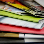 A variety of Saddle Stitched books arranged on a table