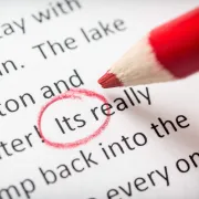 A spelling error being circled in red while Proofreading a document