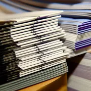 Stacks of printed brochures and booklets