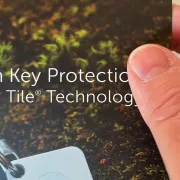 A hand holding a printed brochure that has a soft touch finish