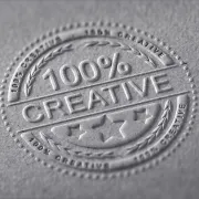 A circular emblem embossed into textured paper