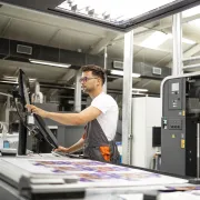 A press operator working in a printing factory