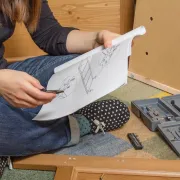 A young woman reading a Product Assembly Manual