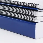A variety of softcover books aligned in a stack