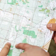 Hands holding a printed map