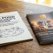 A self-cover booklet lying next to a plus cover booklet on a wooden table