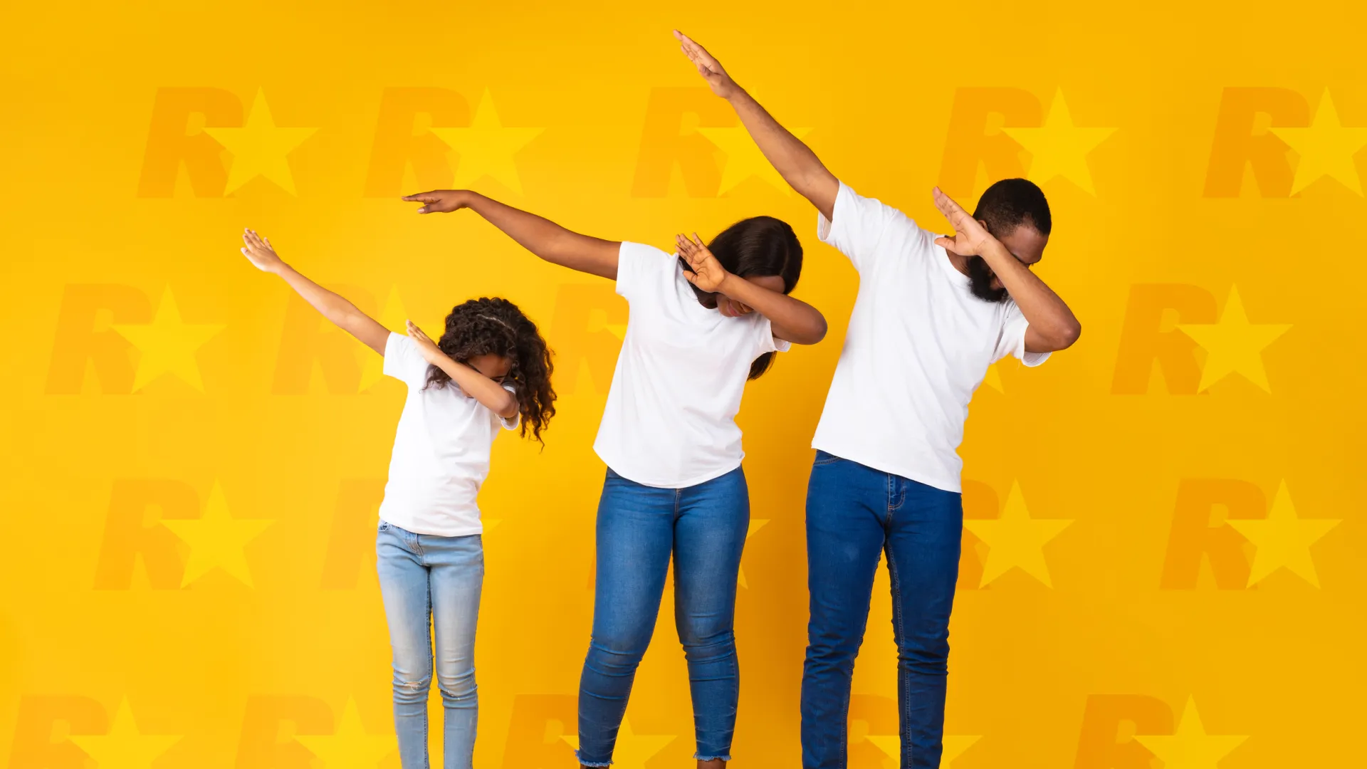 a group of people standing in front of a yellow wall