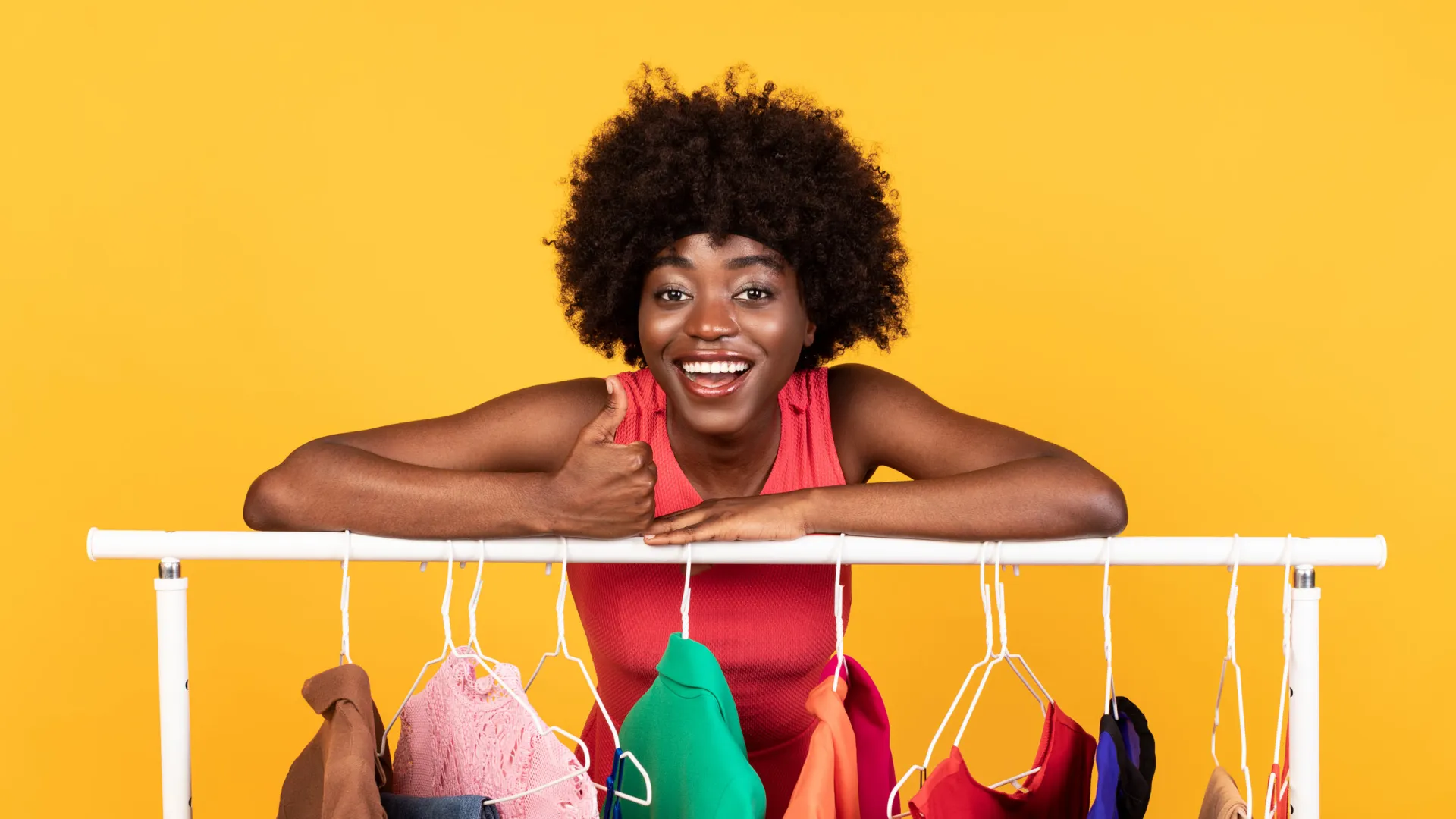 a person holding a rack of clothes