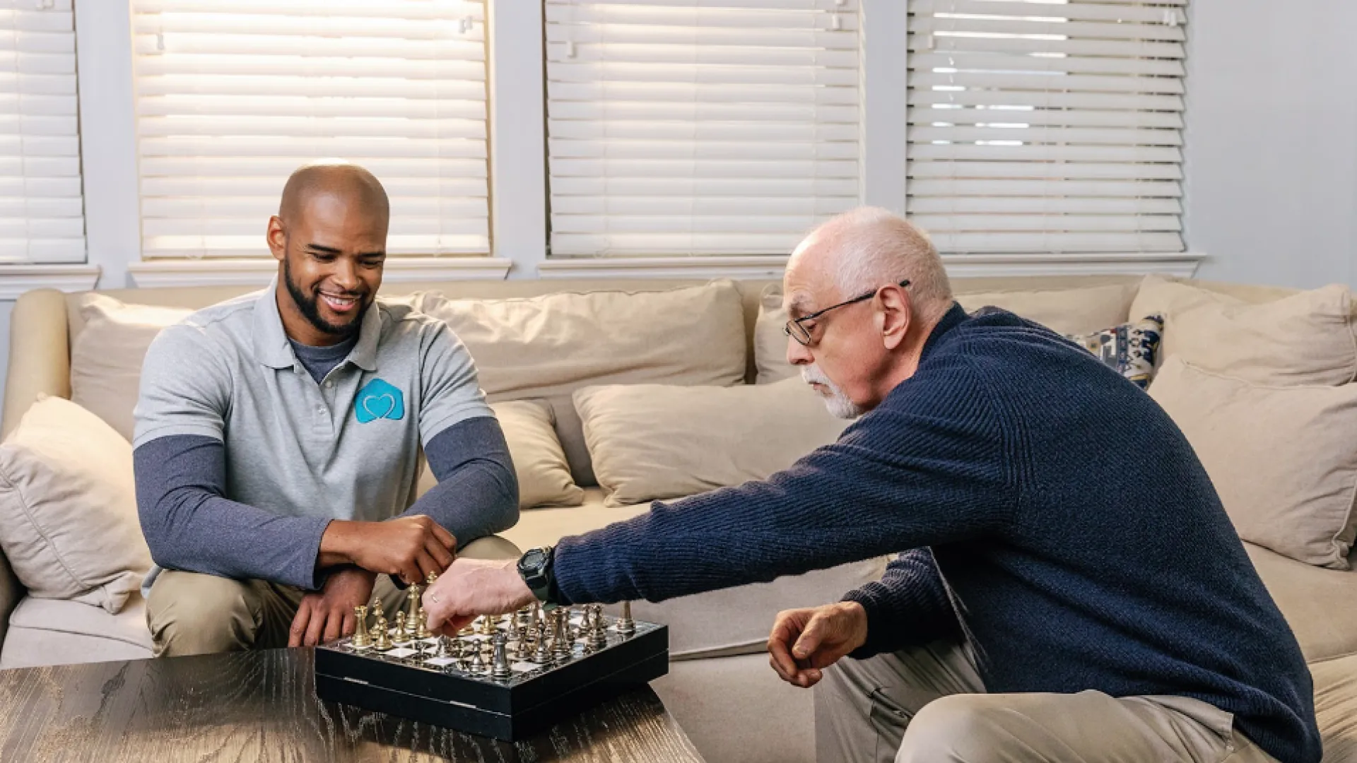 A Caregiver playing a board game with a client on a couch