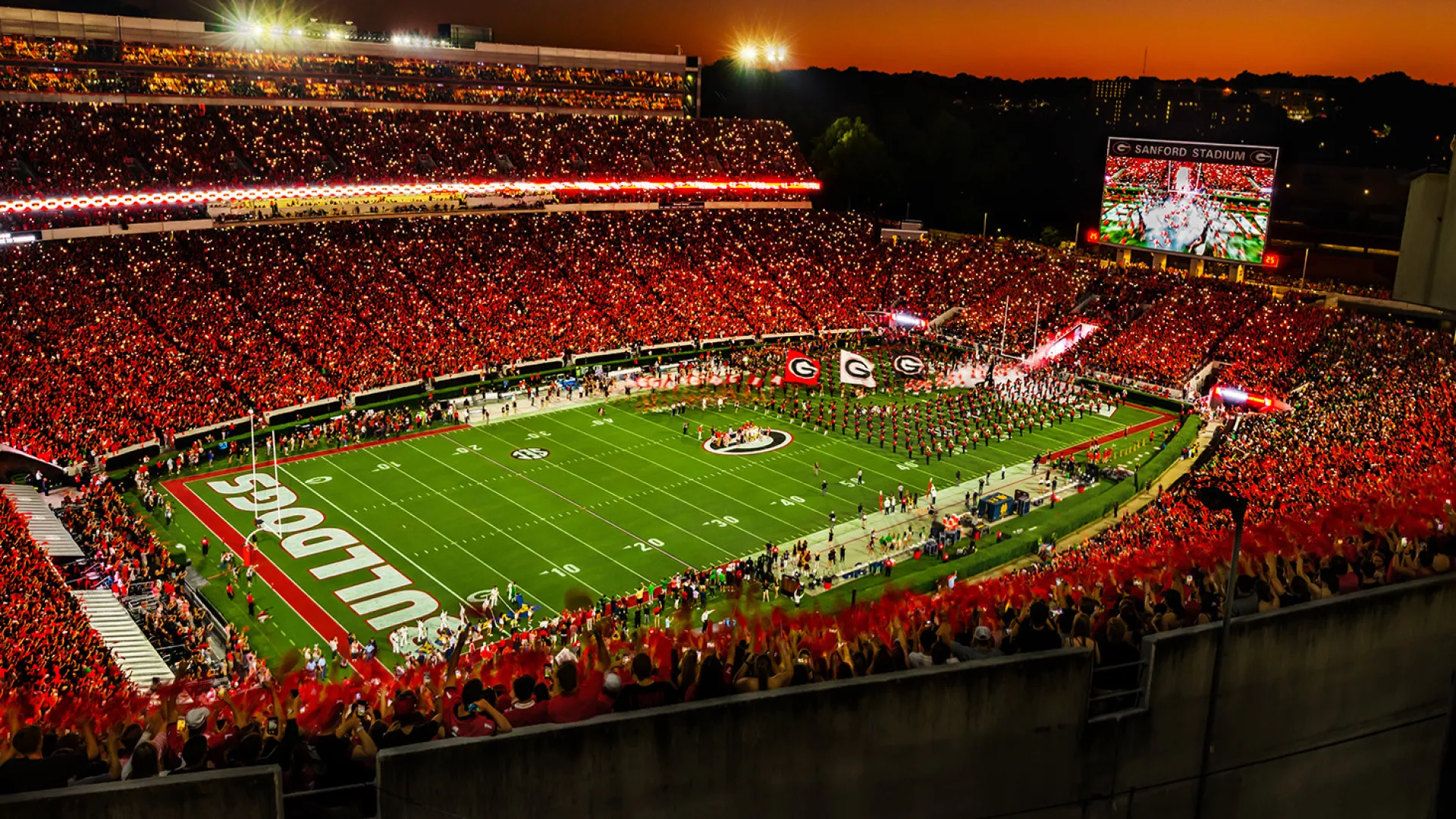 Crowd fills Sanford Stadium at sunset for a University of Georgia Bulldogs football game.