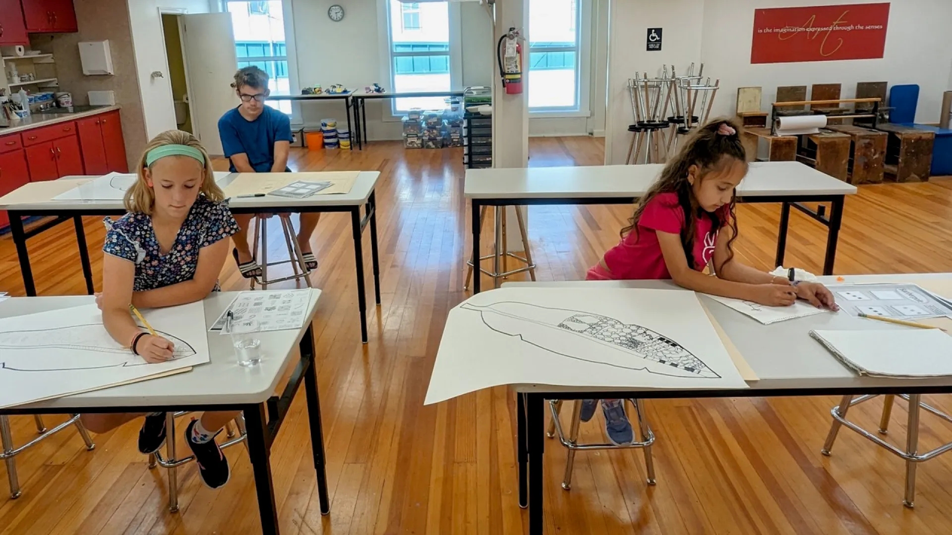 a group of people sitting at desks in a classroom