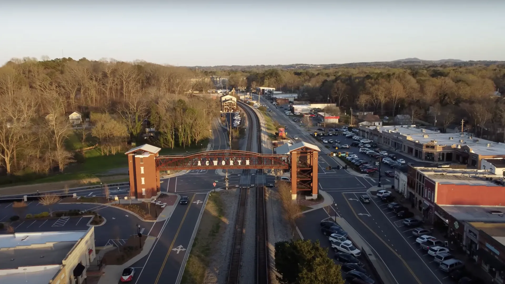 Aerial view of the historic downtown blue ridge railroad tracks and gateway arch in Acworth Georgia at sunset