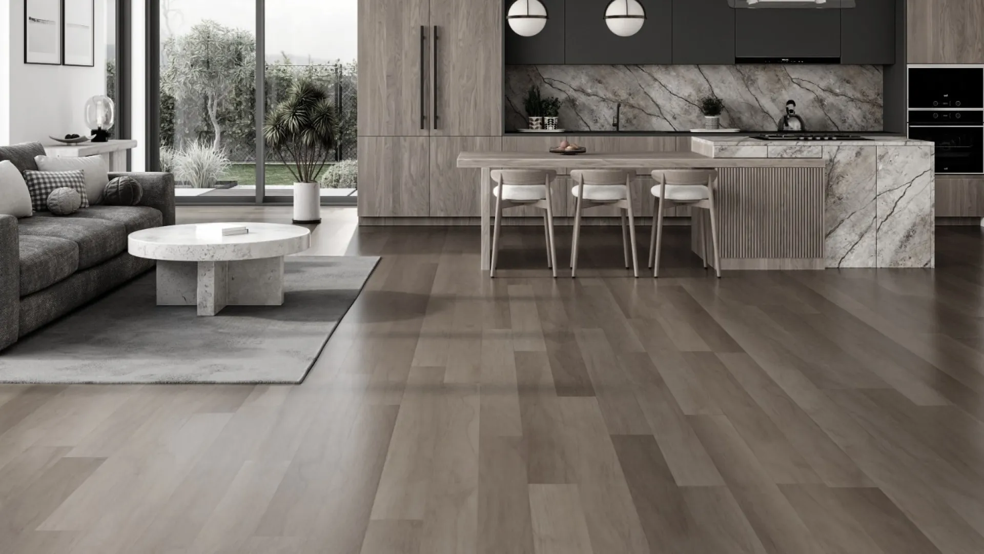 Modern open-concept living room and kitchen with gray sofa, marble island, large windows, and wood flooring.