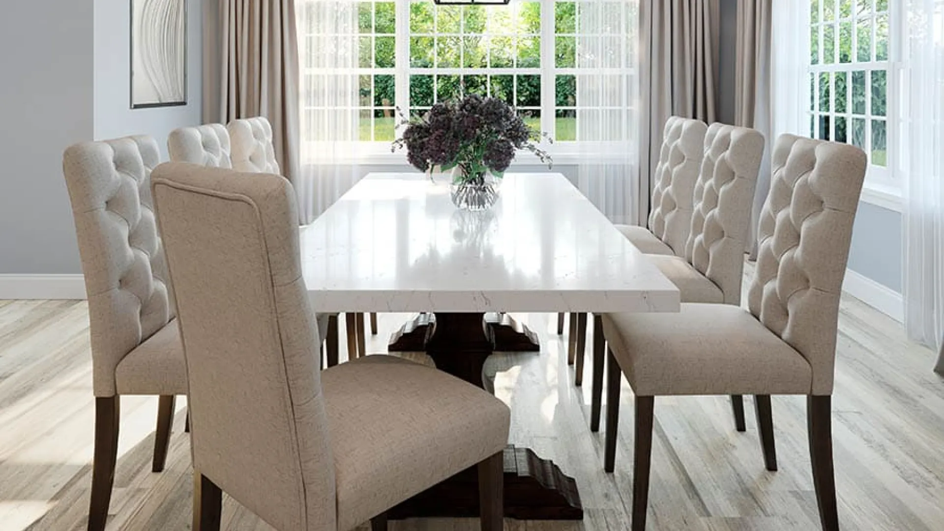 Bright modern dining room with tufted beige chairs, white table, large windows, and contemporary chandelier.