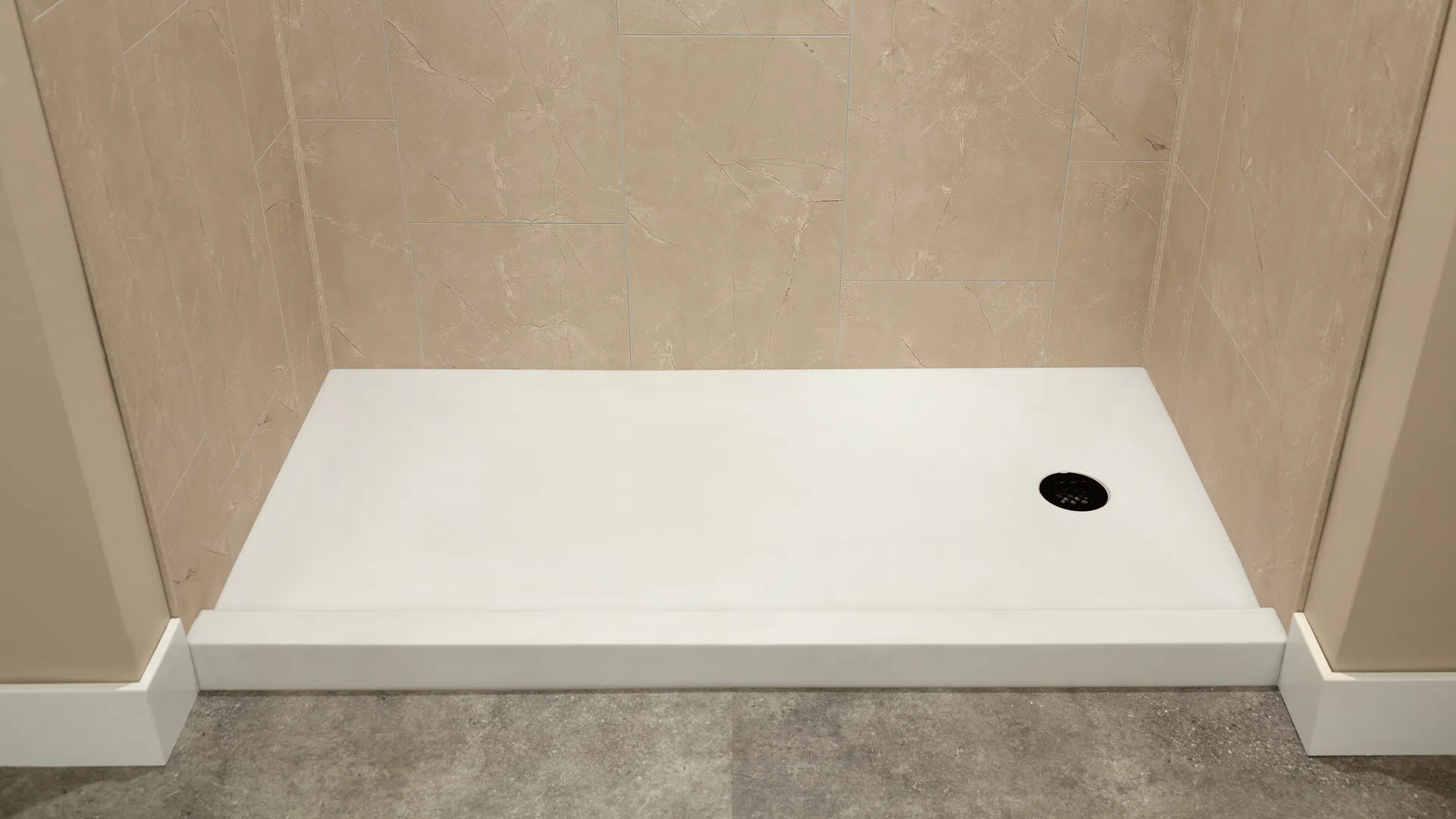 Minimalist rectangular white shower base with beige tiled walls and gray floor tiles in modern bathroom