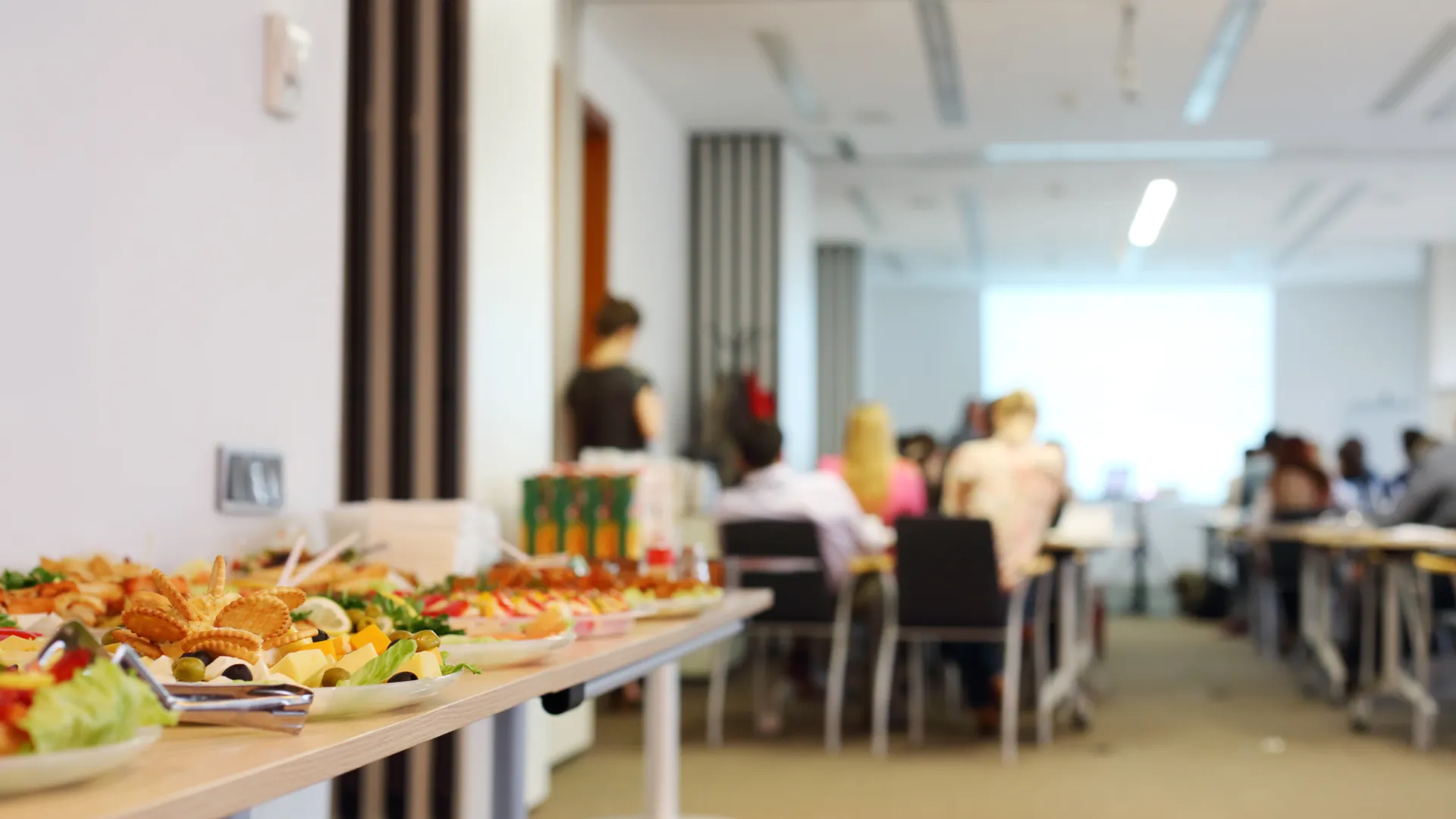 a room with tables and chairs with food on them