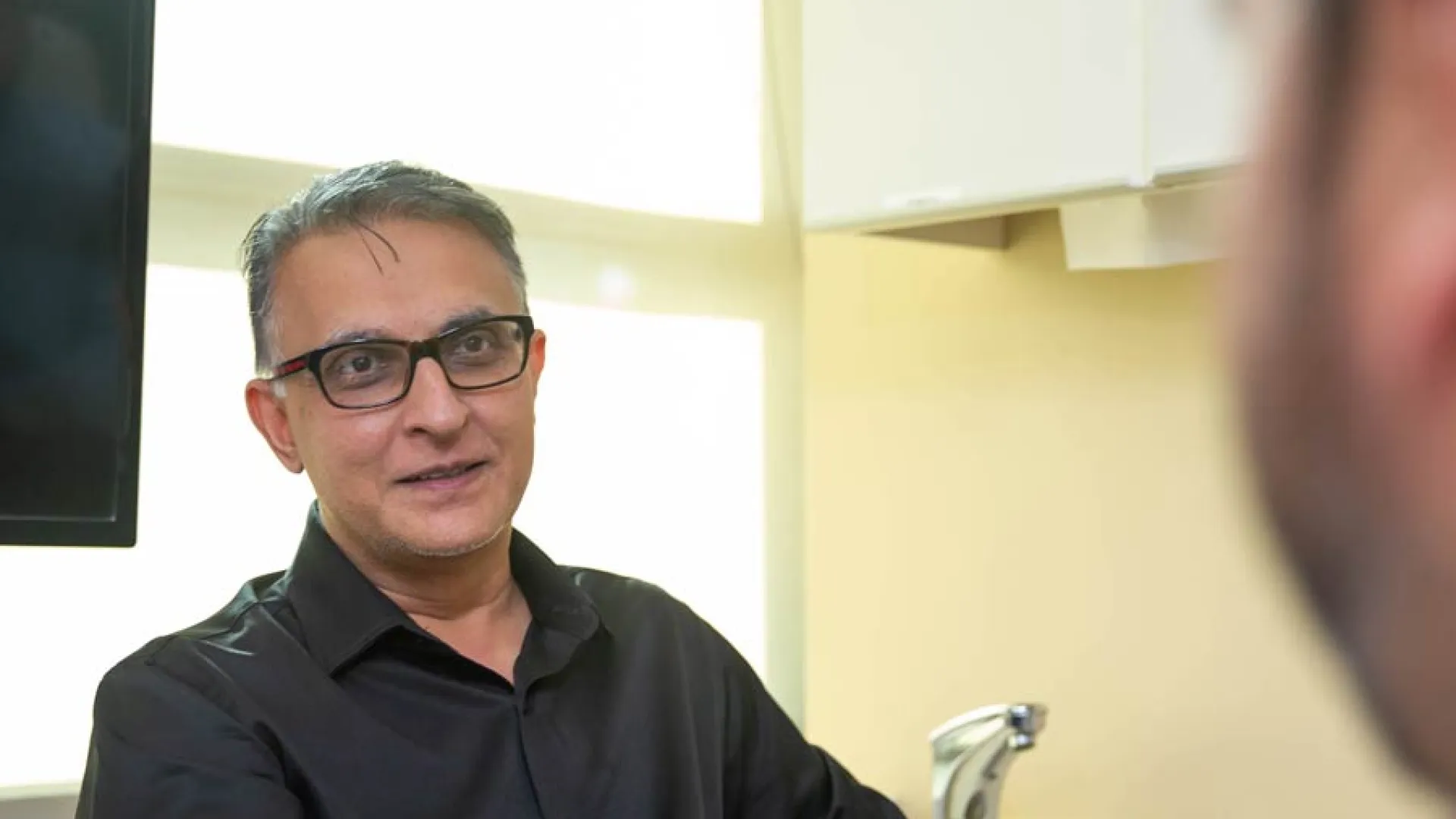 A focused discussion between a doctor and patient in a modern medical office.