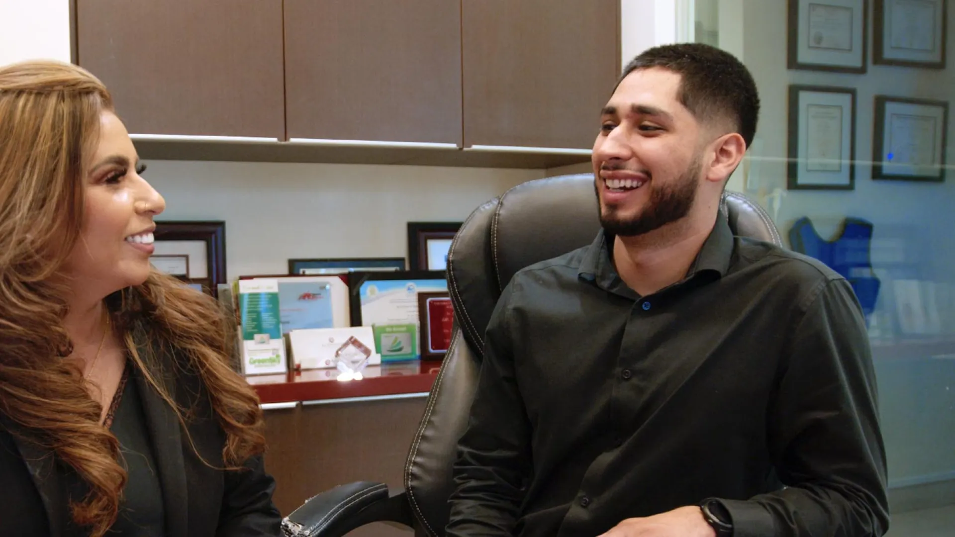 A dentist discussing treatment with a patient in a modern dental office setting.