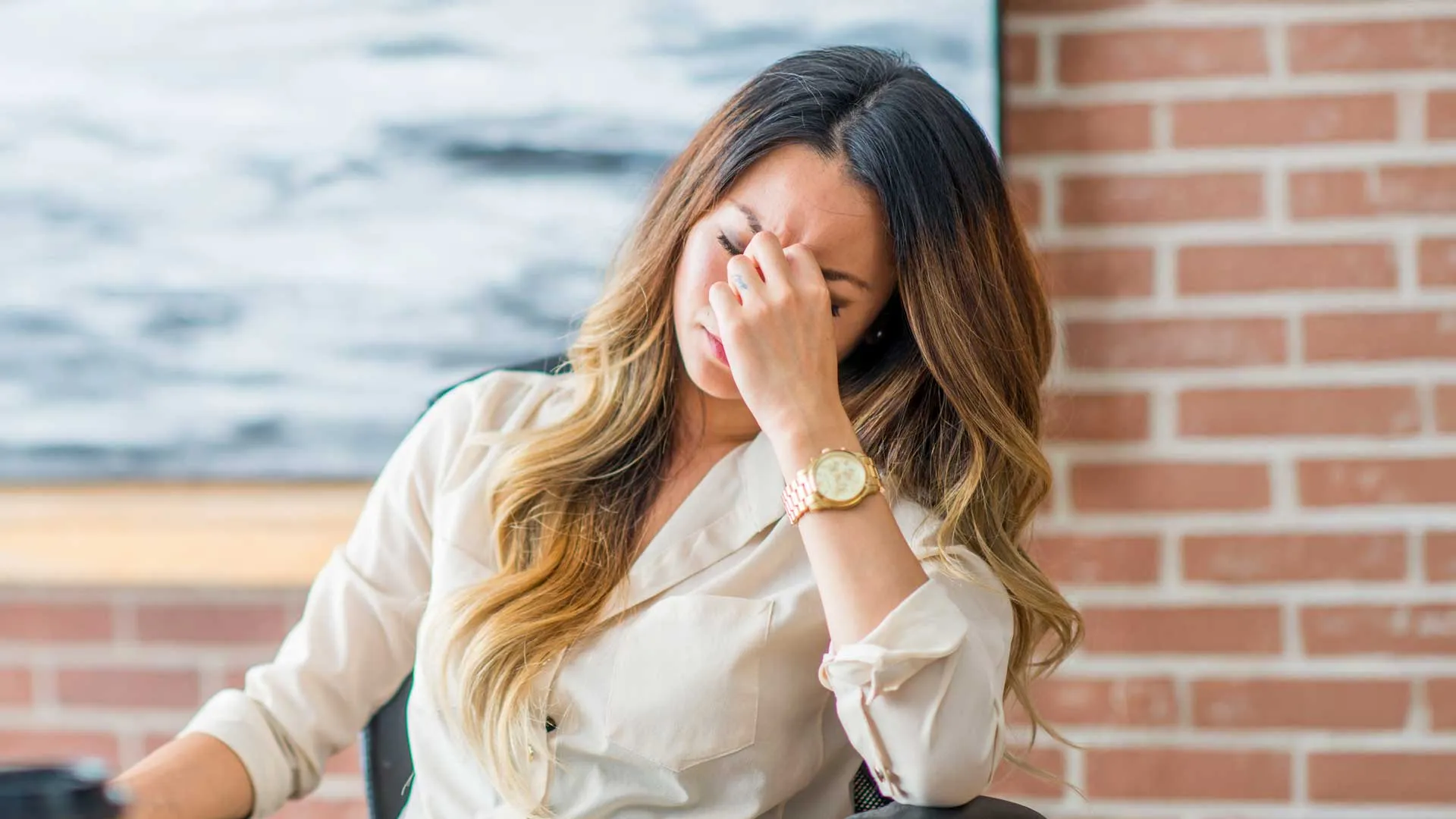 a woman covering her face with her hand