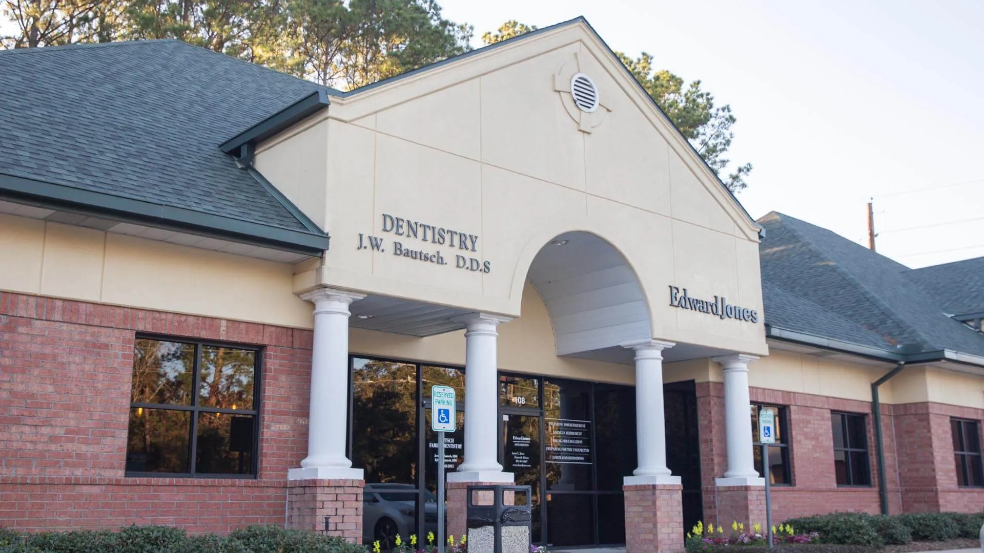Exterior view of a dental office with signage for J.W. Bautsch DDS and Edward Jones under a covered entrance