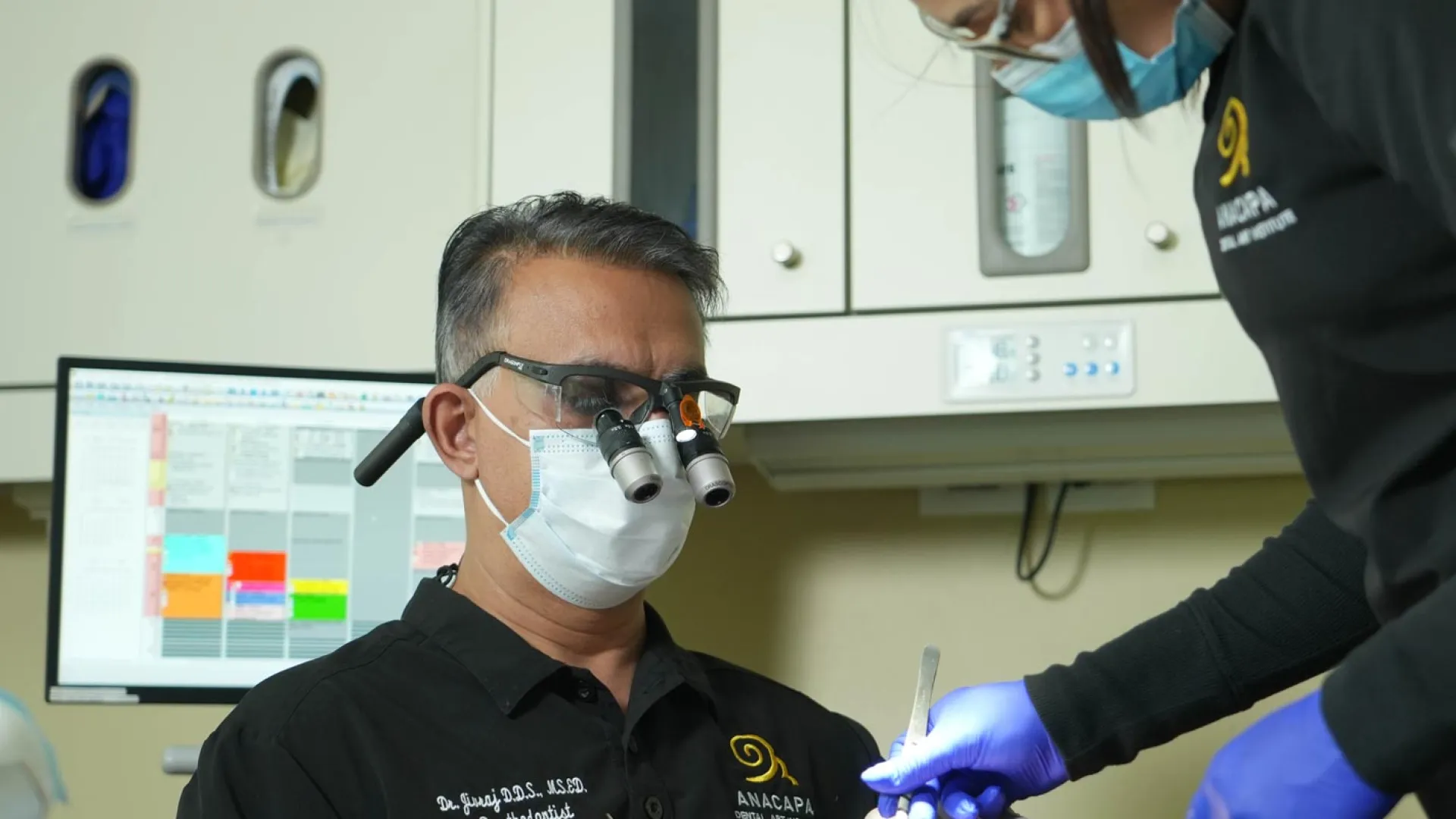 A dentist performing an intricate procedure on a patient using specialized instruments.